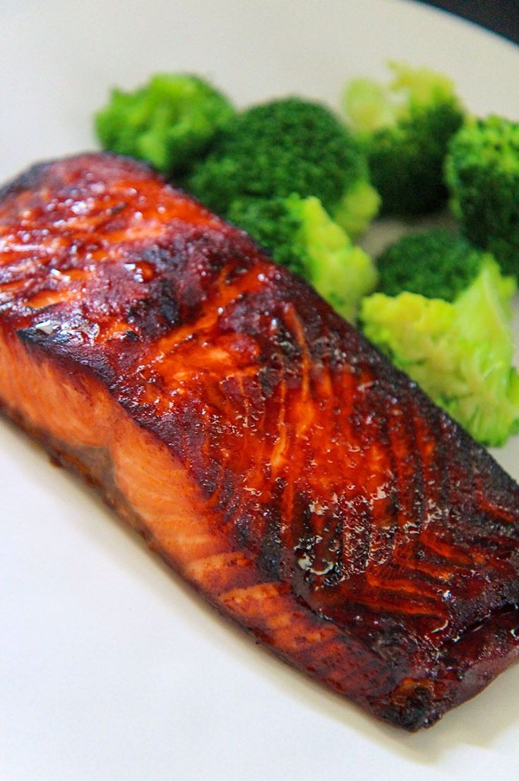 a piece of salmon and broccoli on a plate