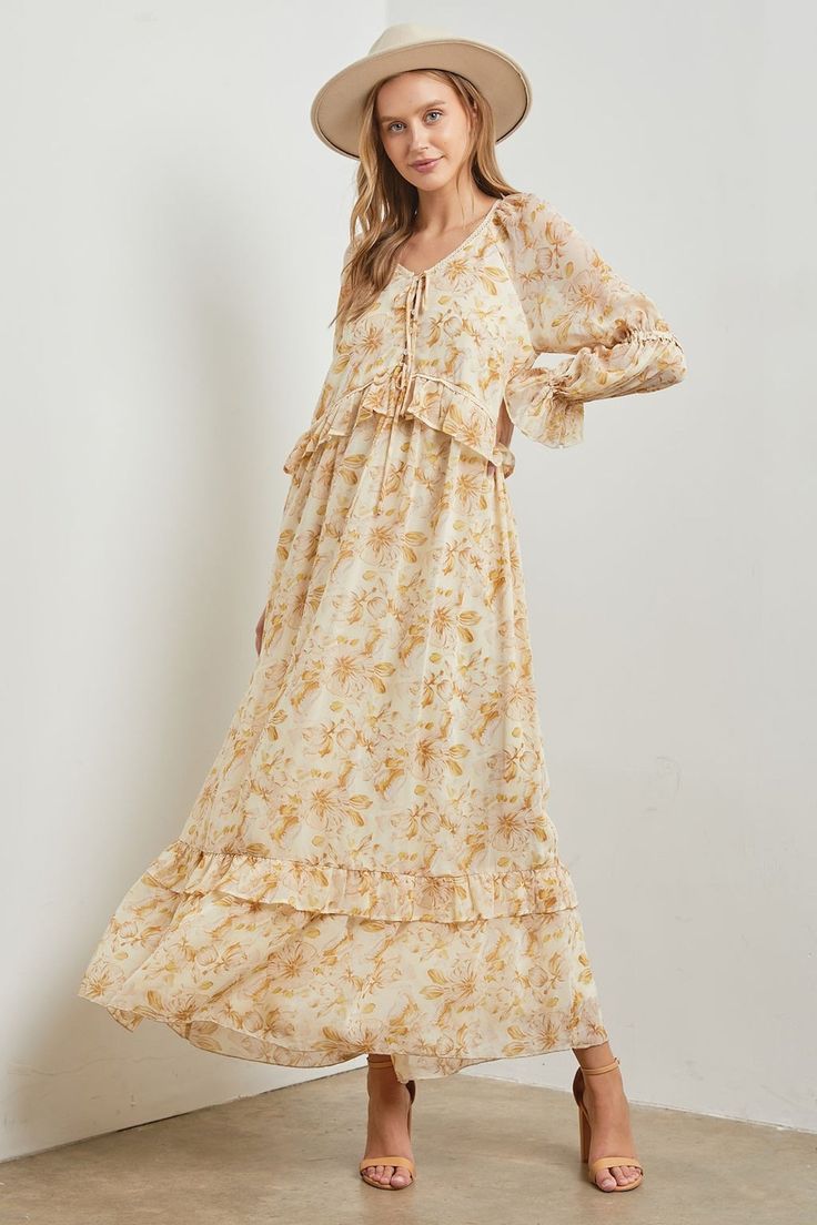 This Stella Floral Long Sleeve Maxi Dress features a stunning floral print and ruffle trim for a boho chic look. Made with chiffon flowy fabric, it offers a relaxed fit and long sleeves for added comfort. Elevate your style with this must-have dress. floral print long sleeves lined ruffle trim v-neckline 100% polyester model is wearing a small Billowy Long Sleeve Floral Maxi Dress, Feminine Floral Print Boho Dress For Garden Party, Billowy Long Sleeve Floral Print Dress, Bohemian Dress With Flowy Skirt And Long Sleeves, Spring Floral Long Sleeve Dress With Ruffles, Flowy Floral Dress With Ruffles For Fall, Bohemian Floral Dress For Garden Party With Ruffle Hem, Bohemian Dress With Ruffle Hem, Spring Floral Print Boho Dress