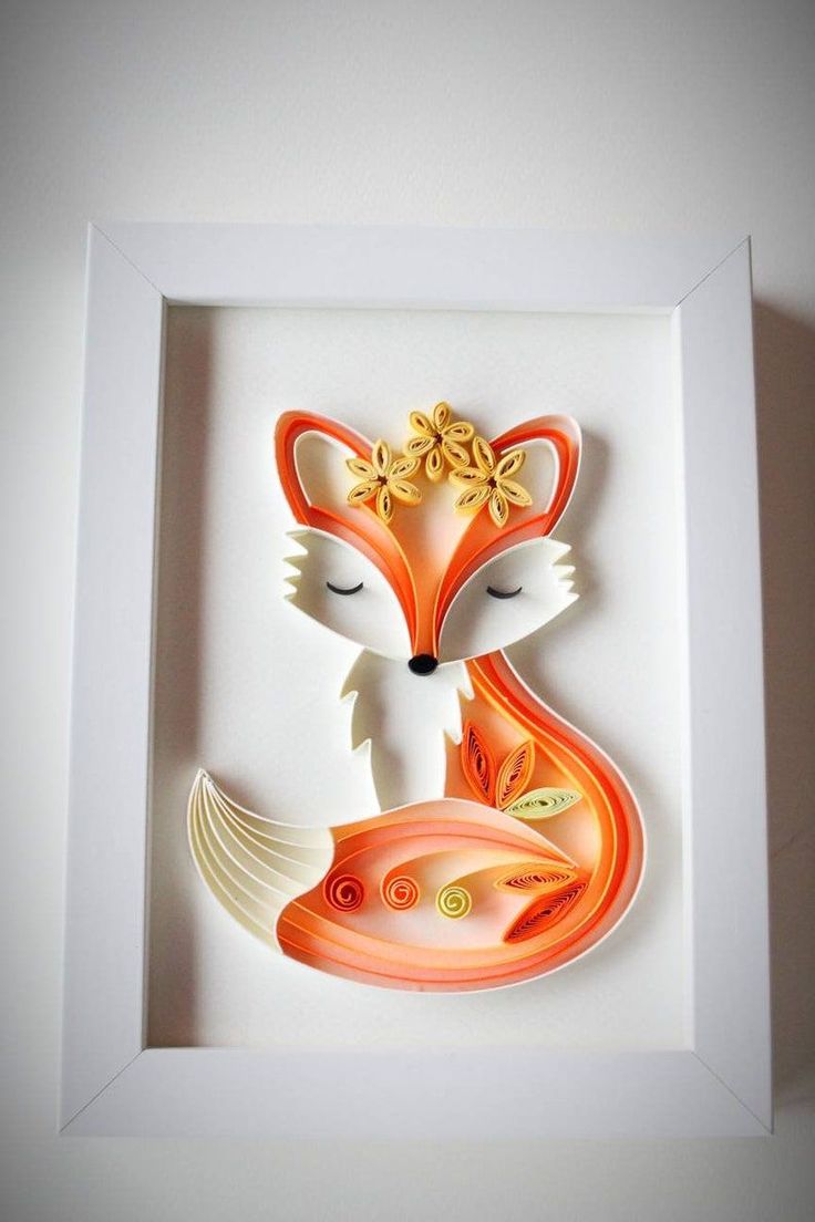 an orange and white paper cut out of a fox with flowers on its head, in a white frame