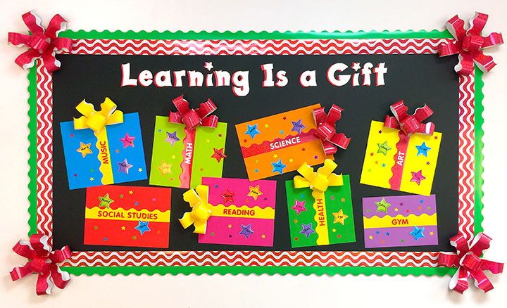 a bulletin board is decorated with brightly colored gift boxes and ribboned bows on it