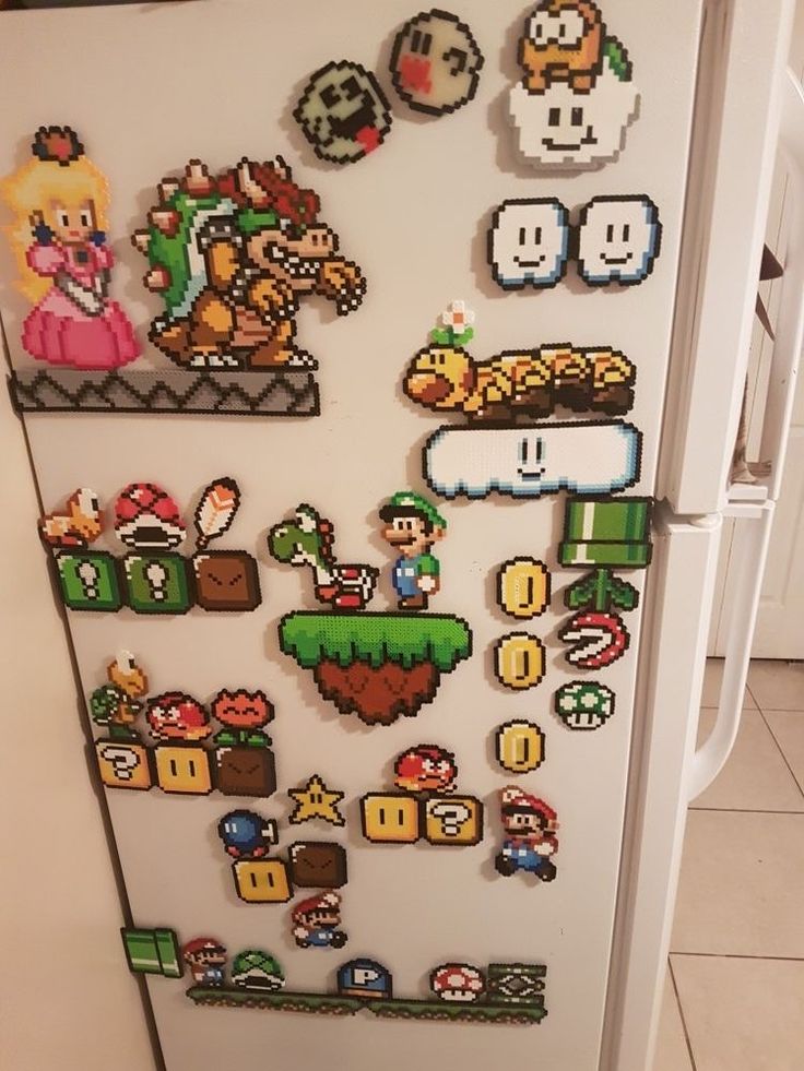 a refrigerator covered in lots of different types of magnets on the side of it