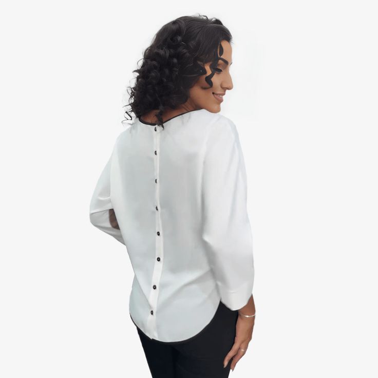 This blouse is not only a fashion statement but is pleasingly comfortable too. Made from soft and flowy material, it feels like a feather against your skin. The graphic detail on this blouse is an elegant celebration of art and pattern. Its back showcases an elegant row of buttons, adding a sophisticated touch to the overall design. View the fit type tab to see how it fits. Flowy V-neck Top For Work, Chic White Long Sleeve Crew Neck Top, Chic White Crew Neck Long Sleeve Top, Elegant V-neck Blouse With Relaxed Fit, Elegant Flowy Tops For Party, Flowy Elegant Party Tops, Elegant Crew Neck Top With Relaxed Fit, Relaxed Fit Long Sleeve Blouse With Back Button Closure, V-neck Top With Back Button Closure For Office