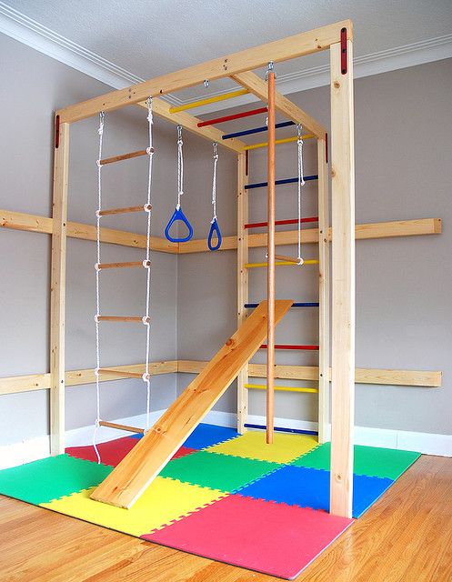 a play room with ladders and climbing ropes