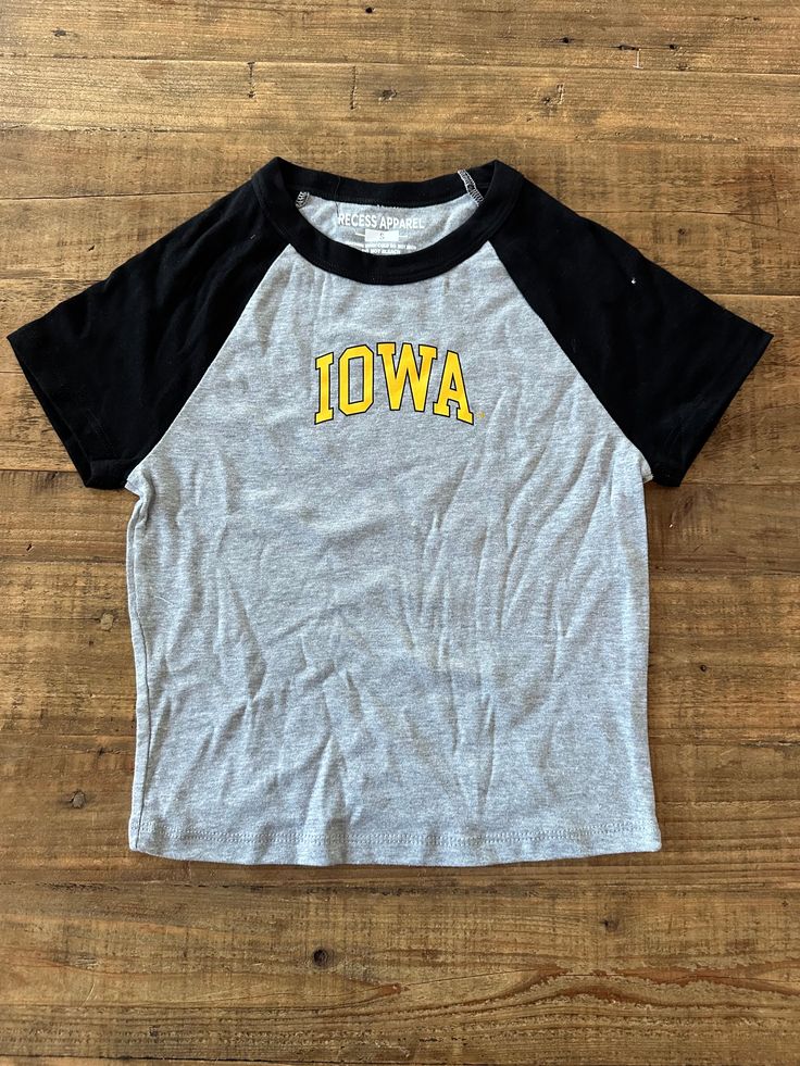 This Iowa Block Baseball Crop Tee is perfect for showing your team spirit. It's made from lightweight cotton-blend fabric and features a crop length, along with raglan sleeves and baby ribbed details. Show off your style and support your favorite team. Relaxed Fit Cropped Cotton T-shirt For Sports, College Team-colored Cotton Baseball Jersey, College Baseball Jersey In Team Colors, Casual Raglan Sleeve T-shirt For College, Game Day Cotton Baseball Jersey With Team Logo, Varsity Crew Neck Top With Team Logo, Varsity Cotton T-shirt For Baseball Season, Short Sleeve Tops For Game Day With School Spirit, Casual Jersey T-shirt For Game Day