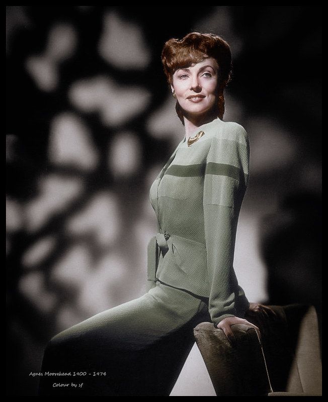 a woman in a green suit posing for a photo