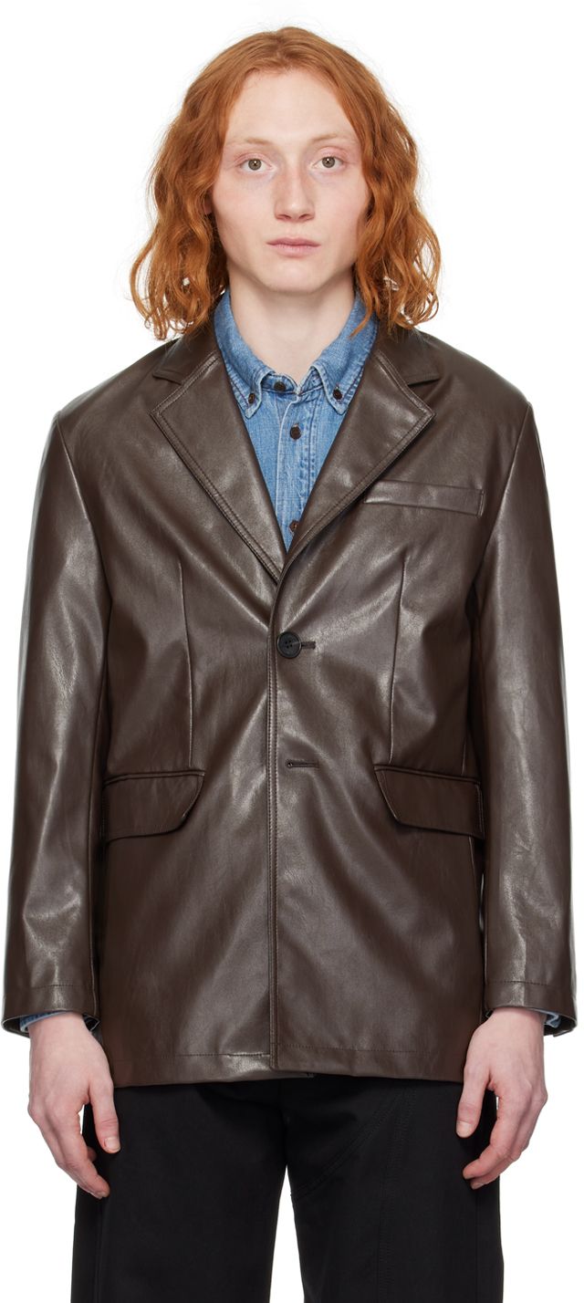 Grained faux-leather blazer. · Notched lapel · Button closure · Welt pocket at chest · Flap pockets · Padded shoulders · Four-button surgeon's cuffs · Central vent at back hem · Welt pocket at interior · Full satin lining Supplier color: Brown Fall Formal Leather Jacket With Snap Buttons, Formal Fall Leather Jacket With Snap Buttons, Formal Leather Jacket With Snap Buttons For Fall, Brown Blazer With Lapel Collar And Double Button Closure, Brown Blazer With Double Button Closure And Lapel Collar, Brown Blazer With Button Closure For Office, Leather Blazer With Snap Buttons And Lapel Collar, Brown Business Blazer With Button Closure, Leather Blazer With Snap Buttons For Office