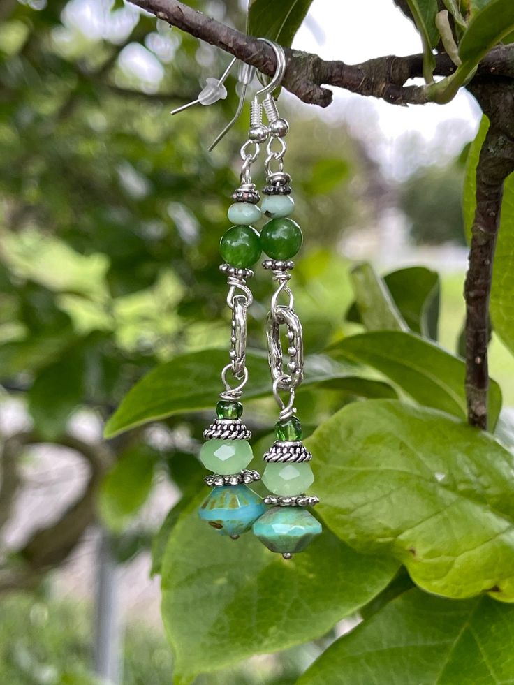 Czech green colored glass beads. Sterling silver and mixed metals. 2 inches in length Green Jade Earrings For May Birthstone, Green Dangle Chandelier Earrings, Green Adjustable Jewelry With Matching Earrings, Green Crystal Metal Earrings, Green Dangling Bead Chandelier Earrings, Handmade Green Crystal Metal Earrings, Jade Beaded Earrings For Jewelry Making, Green Bohemian Chandelier Earrings, Green Czech Glass Jewelry