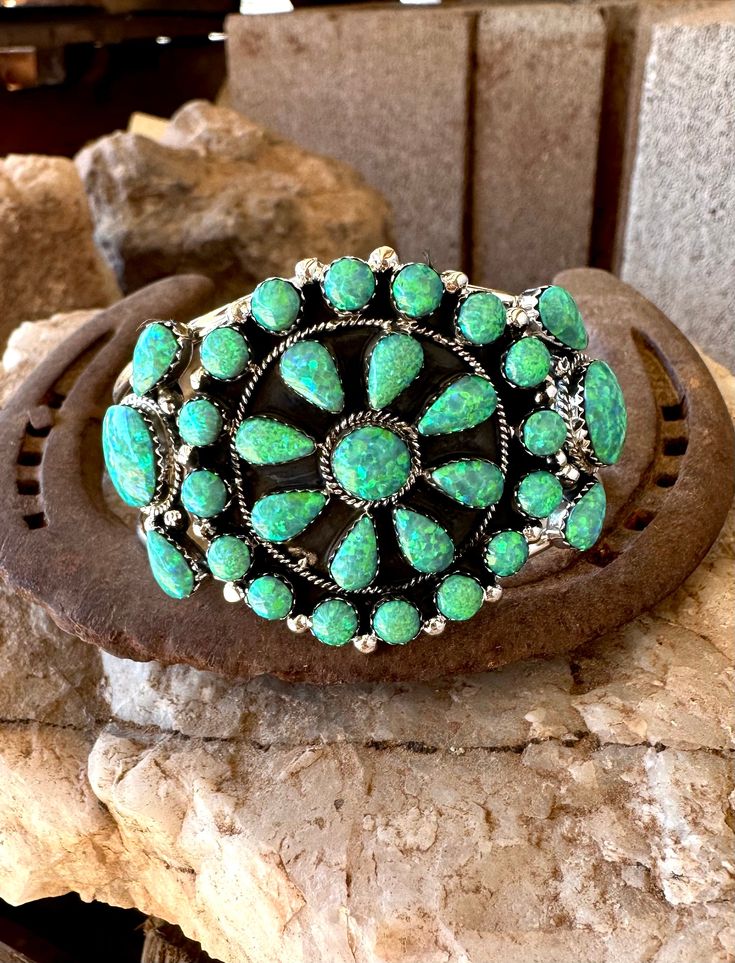 This Cluster Cuff is so beautiful with 31 stones inlaid in .925 sterling silver all handmade in the USA, choose from our colors Hot Pink Opal, Neon Green, Campitos Blue and White Buffalo! Southwestern Multi-stone Green Jewelry, Southwestern Green Multi-stone Jewelry, Southwestern Style Green Multi-stone Jewelry, Green Southwestern Style Jewelry With Inlay, Southwestern Style Green Inlay Jewelry, Southwestern Gemstone Bangle Jewelry, Southwestern Multi-stone Bracelet Jewelry, Southwestern Style Bracelet With Inlay, Southwestern Style Jewelry Bracelet With Inlay