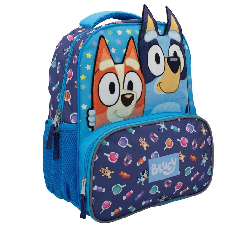 Your kiddo will love this Candy Jam Bluey Backpack! Let them flaunt this bag around EVERYWHERE and ANYWHERE. The backpack features a Bluey and Bingo plush applique, all over bluey print on the front, side, back straps and even on the interior pocket! This 14" kids backpack is designed with a spacious main zippered compartment with a separate padded laptop sleeve for storing their books, laptop/tablet, lunch, supplies or other essentials. It also features an exterior zip pocket in front for safe School Bags With Cartoon Print For Back To School, Cute Blue Backpack For Back To School, Playful School Bag With Character Print, Blue Cartoon Bags For Back To School, Blue Cartoon Backpack For Everyday Use, Blue Cartoon Backpack Bag, Blue Cartoon Style Backpack Bag, Blue Cartoon Backpack, Cute Blue Softback Backpack