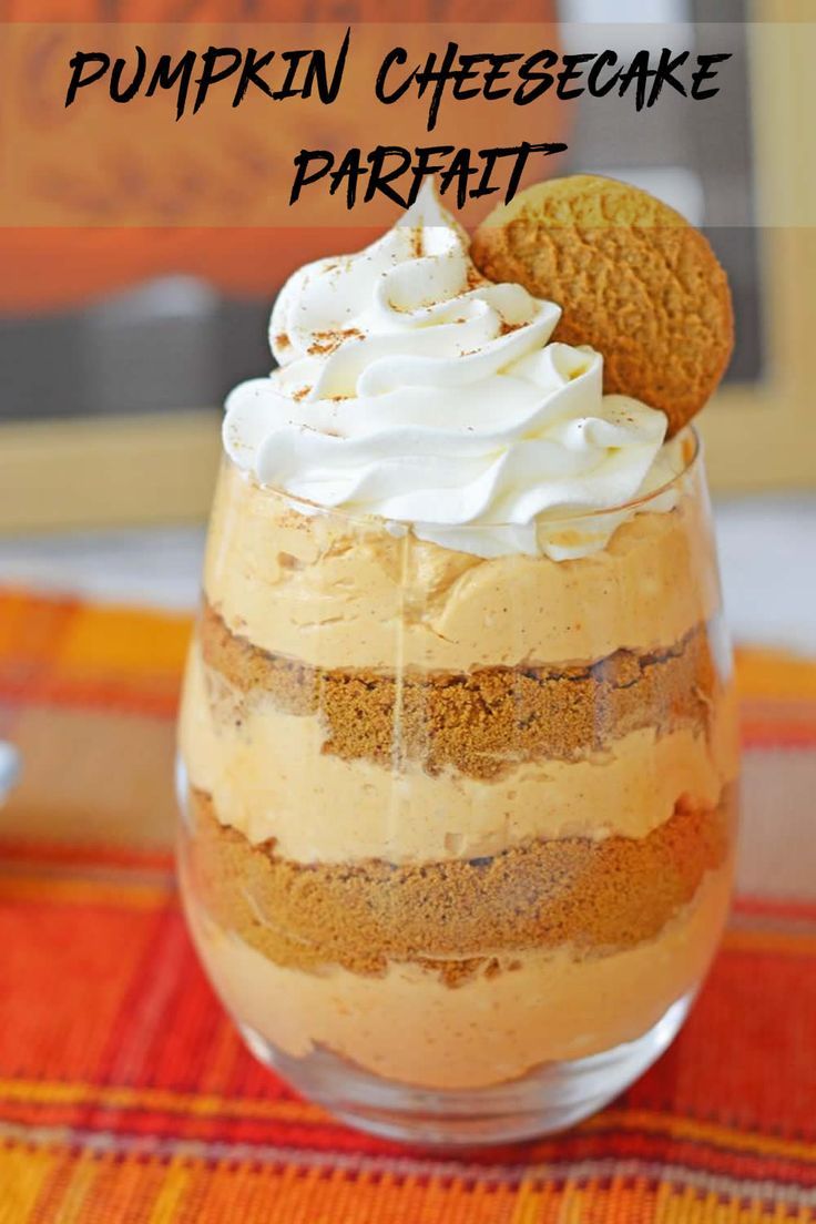 a dessert in a glass with a cookie on top and whipped cream around the edge