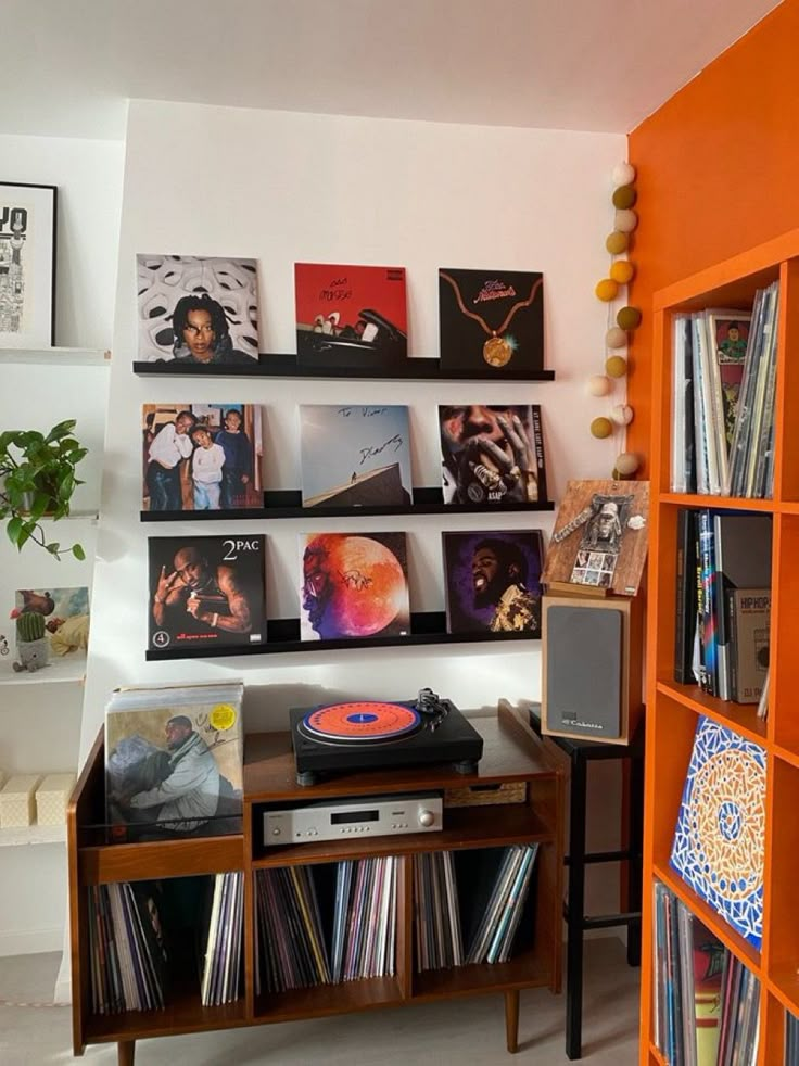 an orange book shelf filled with vinyl records