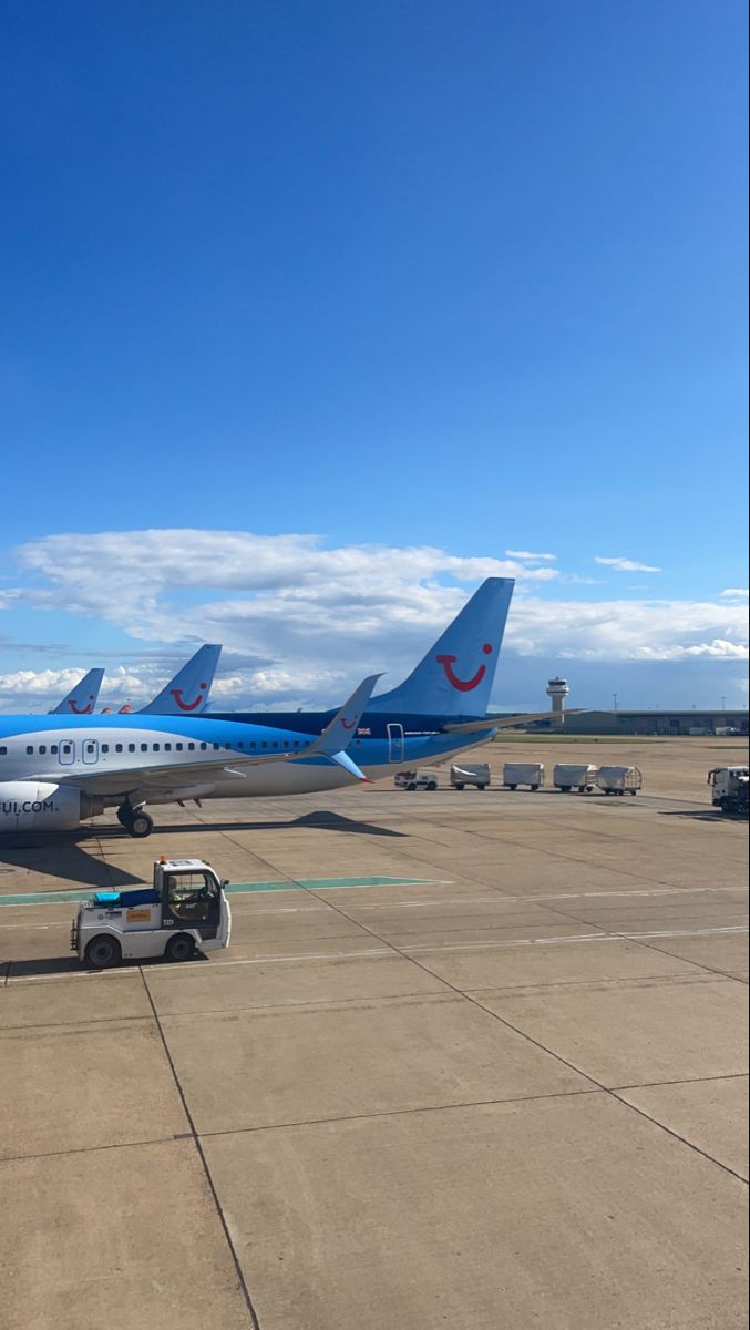 several airplanes parked on the tarmac at an airport