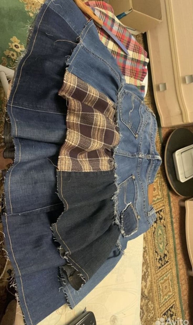 a pile of jeans sitting on top of a floor