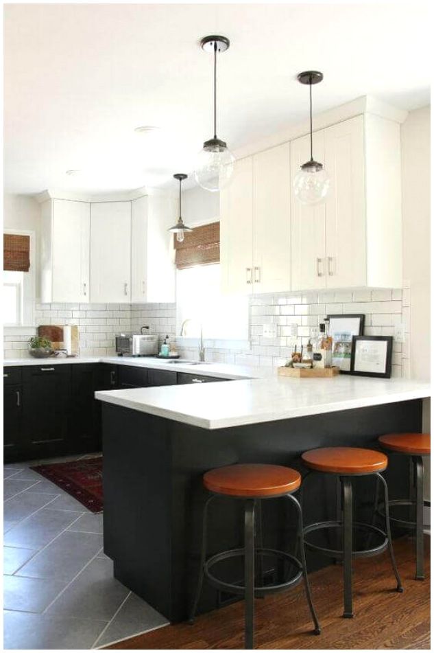 a kitchen with black and white cabinets, wood stools and an island in the middle