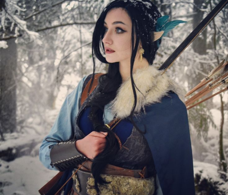 a woman dressed as snow queen in the woods