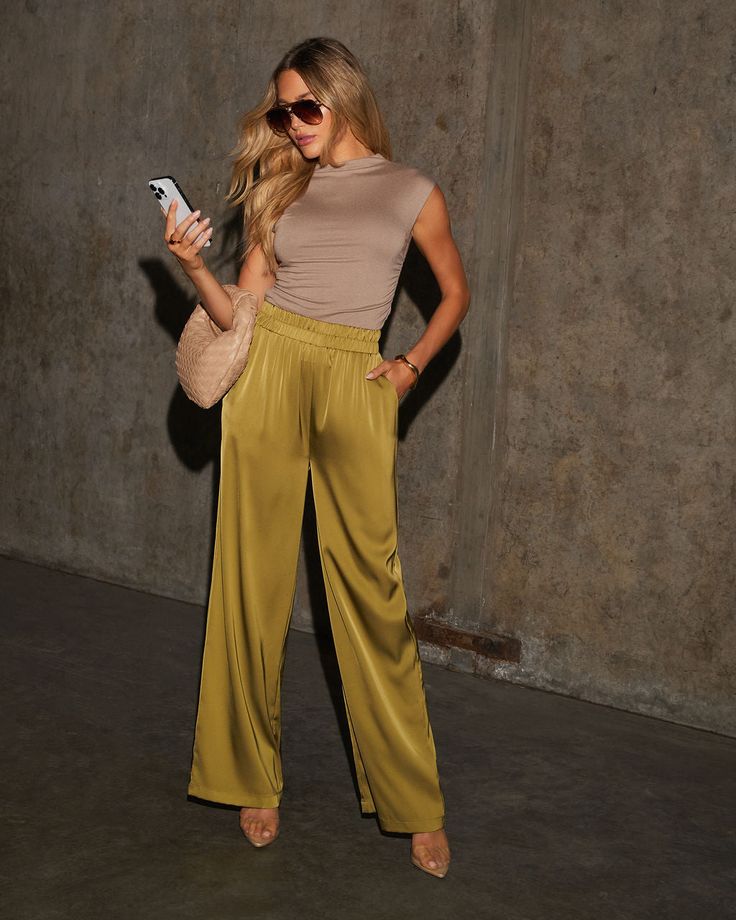 Meet the Zola High Waisted Satin Pants—a perfect fusion of chic and relaxed! Crafted from luxurious satin, these pants drape effortlessly, combining sophistication with ultimate comfort. The high-waisted design and smocked waistband ensure a flattering fit, while the smooth satin fabric adds a touch of elegance to your everyday ensemble. Whether you're heading to a brunch date or a casual office day, these pants are versatile enough to dress up or down. Satin fabric Side slant pockets Smocked wa Yellow Satin Pants, Chartreuse Pants Outfit, Silk Pants Outfit Street Styles, Silky Pants Outfit, Palette Closet, Green Satin Pants, Silk Pants Outfit, White Pants Outfit Summer, Satin Pants Outfit