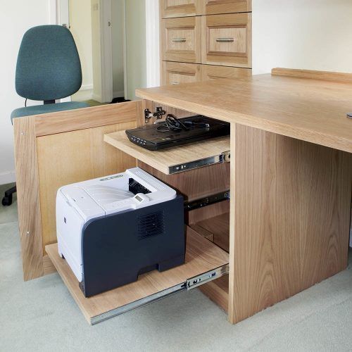 an office desk with a printer on it and a chair in the corner behind it