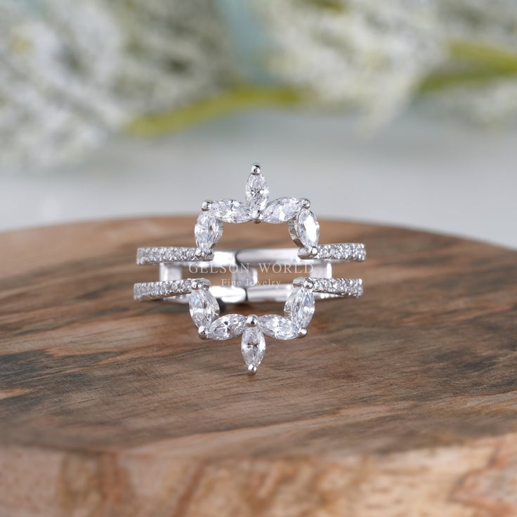 a diamond ring sitting on top of a wooden board