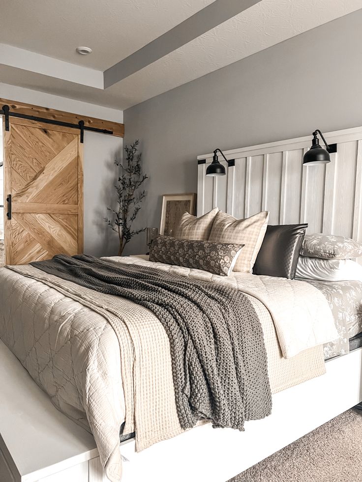 a bedroom with a large bed and wooden headboard