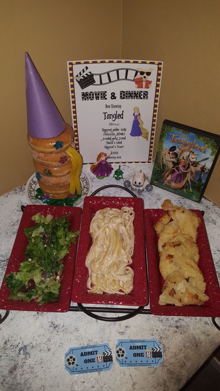 a table topped with red plates filled with pasta and veggies next to an award plaque