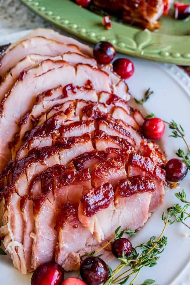 sliced ham with cranberry sauce on a plate