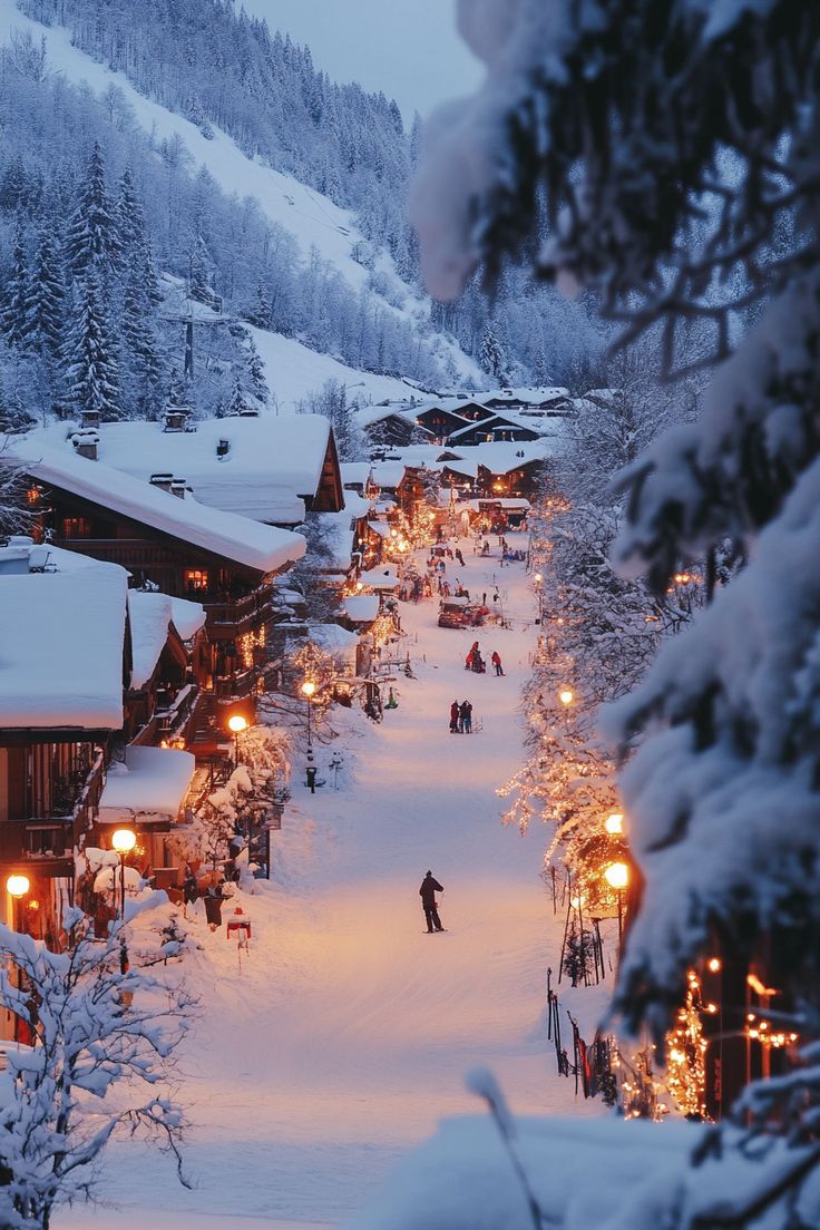 a ski resort at night with people skiing down the hill