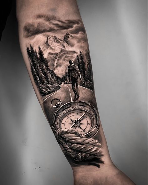 a man with a compass tattoo on his arm