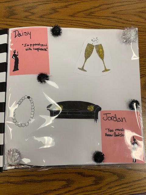 a notepad with black pom poms on top of it, and an image of a woman's dress