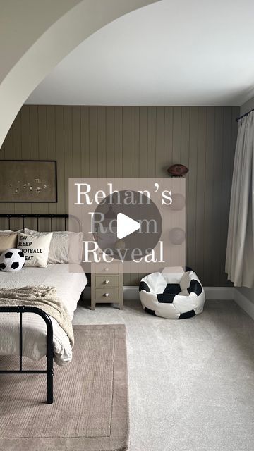 a bedroom with a bed and soccer balls on the floor in front of a window