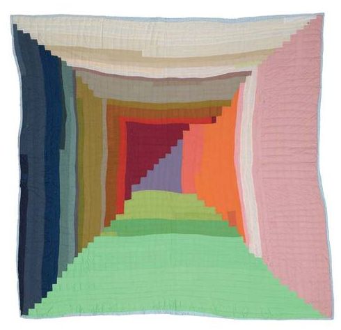 a multicolored quilt is displayed on a white background