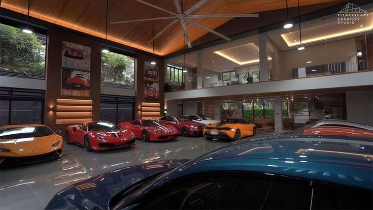 a group of cars parked inside of a garage next to a tall building with high ceilings