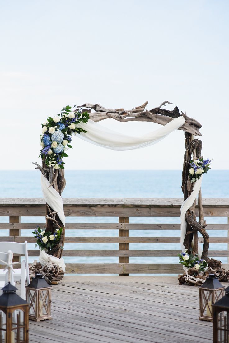 an outdoor ceremony setup with white and blue flowers