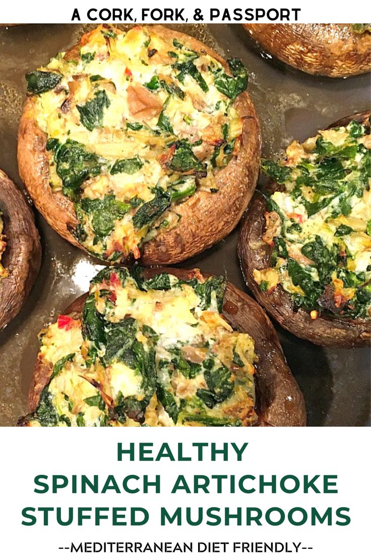 some stuffed mushrooms with spinach and other toppings in them on a baking sheet