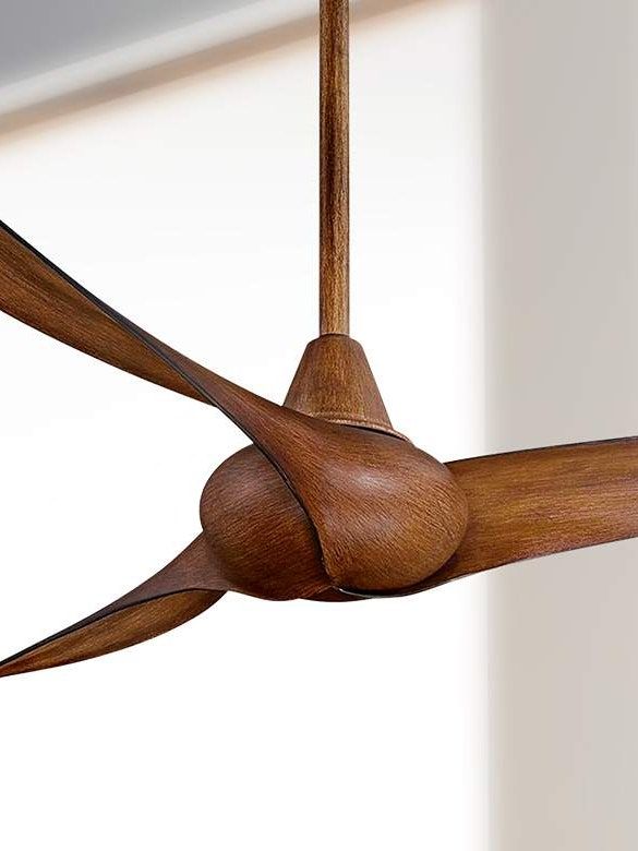 a ceiling fan with wooden blades hanging from it