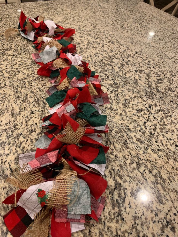 several pieces of burlap and jute ribbon on a granite counter top with chairs in the background