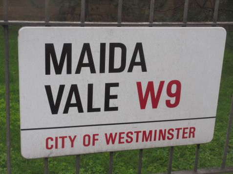 a street sign is posted on a fence