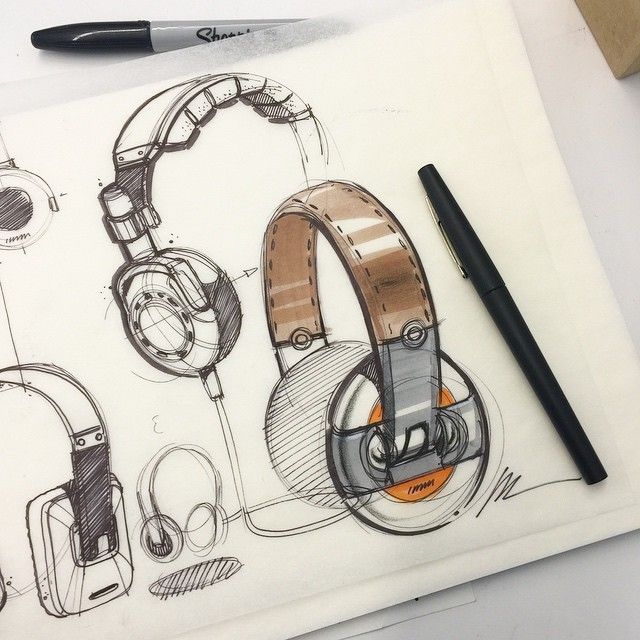 a drawing of headphones on top of a piece of paper with a pen next to it