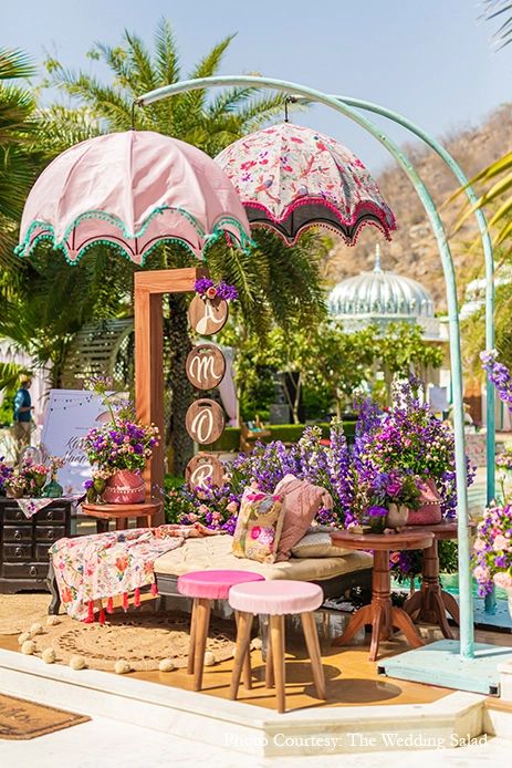 an outdoor area with tables, umbrellas and flowers