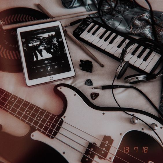 an electronic device sitting on top of a table next to musical instruments