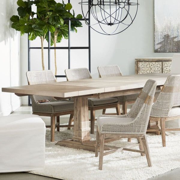 a dining room table and chairs with white rugs