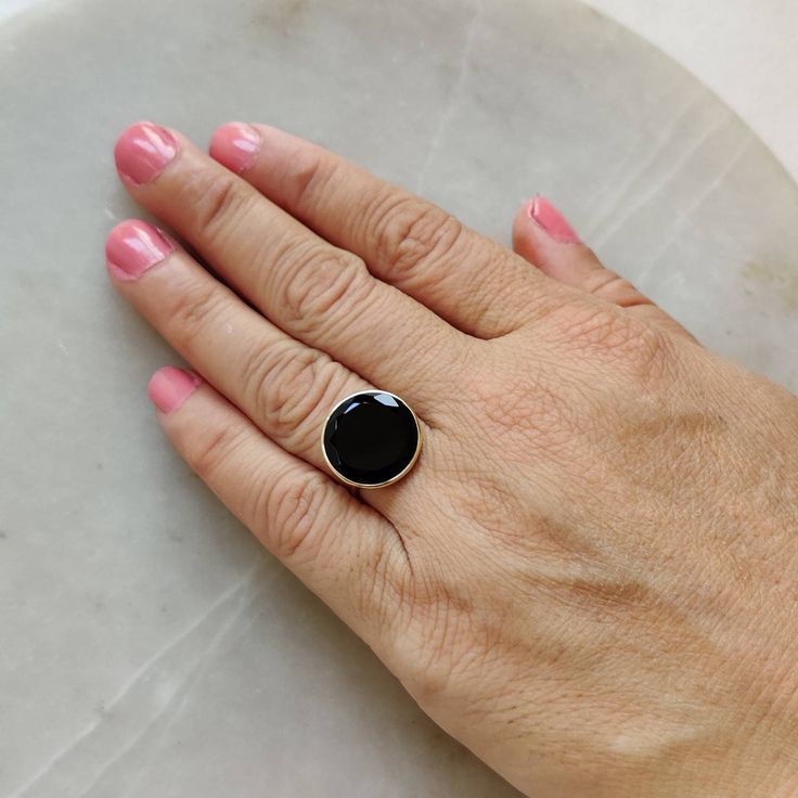 This stunning ring is set in 14k Solid Yellow Gold with Natural Black Onyx with utmost precision. It is an unique statement gemstone ring for nearly every occasion and is completely hassle-free jewelry. ITEM DETAILS *  GEM: Black Onyx * GEM SIZE: 15X15mm * GEM SHAPE: Round * Gem weight: 6.45 carats * Gold Purity: 14KT * Gold Weight: 1.20 gram * Total Weight of the Ring: 2.49 gram The Gold purity is guaranteed and it comes with authentic 14KT gold hallmark. Since my items are handmade, they are absolutely nickel and lead free. CUSTOMIZATION: * Size Customization is available for this ring and it is available in all ring sizes. Kindly choose your ideal ring size from the drop-down. * Gemstone customization is available and the it can be substituted with a gem of your choice. Kindly message m Green Amethyst Ring, Handmade Jewelry Box, Solid Gold Ring, Bezel Ring, Black Onyx Ring, Birthstone Gifts, Alternative Engagement Rings, Solid Gold Rings, Onyx Ring