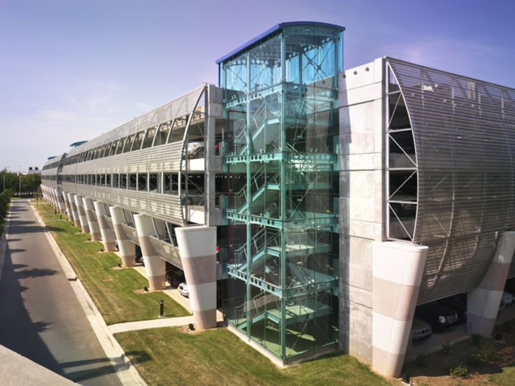 an aerial view of the exterior of a modern building with glass and steel staircases