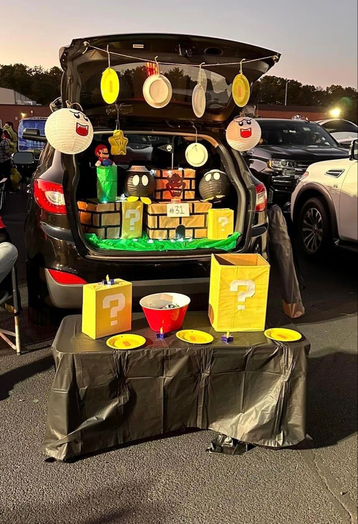 the trunk of a car is filled with items for sale at an outdoor market stall