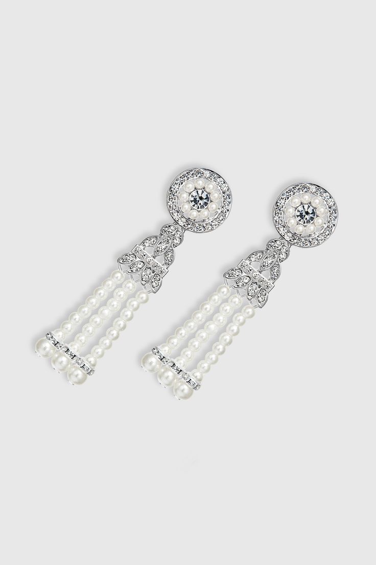 This sumptuous piece of jewelry features a retro-elegant yet slightly modern style that complements the lavish garments, reminiscent of the roaring 1920s. Features: Lustrous imitation pearls and stunning crystals Crystal studded design 2.95 inch / 7.5cm long Dangling pearl tassels Elegant Beaded Bridal Earrings For Party, Elegant Beaded Pearl Earrings, Glamorous Crystal Pearl Earrings For Evening, Elegant Beaded Bridal Earrings, Round Crystal Pearl Earrings For Formal Events, Elegant Beaded Metal Crystal Earrings, Classic Crystal Chandelier Earrings For Party, Elegant White Chandelier Earrings With Rhinestones, Elegant Beaded Chandelier Earrings For Party