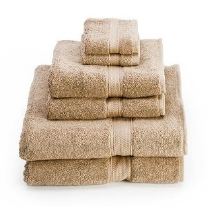 a stack of green towels sitting on top of each other in front of a white background