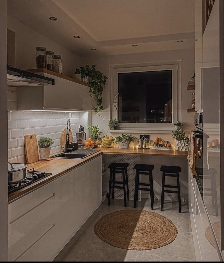 the kitchen is clean and ready to be used for cooking or baking, with stools in front of the counter