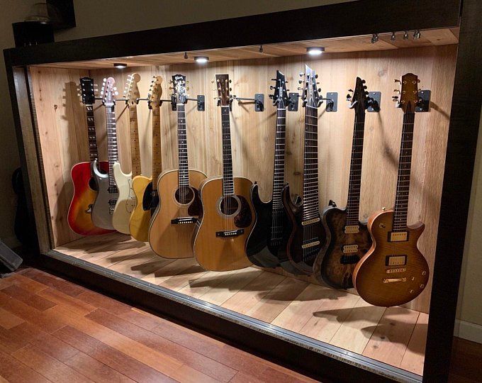 guitars are lined up in a display case