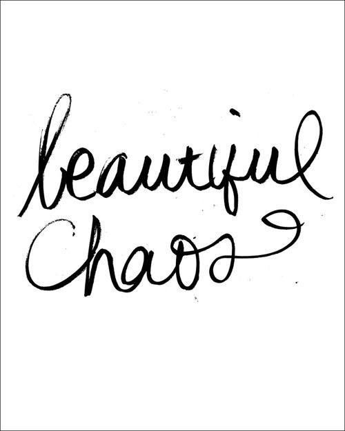 the words beautiful chaos written in cursive ink on a white paper with black ink