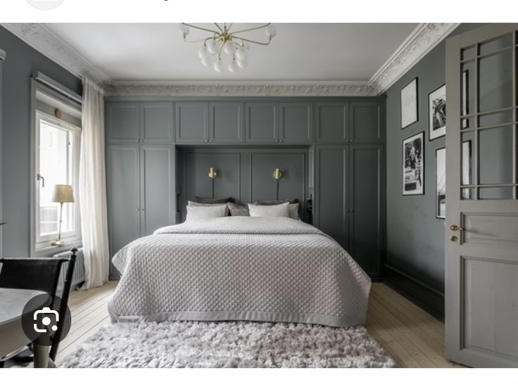 a bed sitting in the middle of a bedroom next to a window