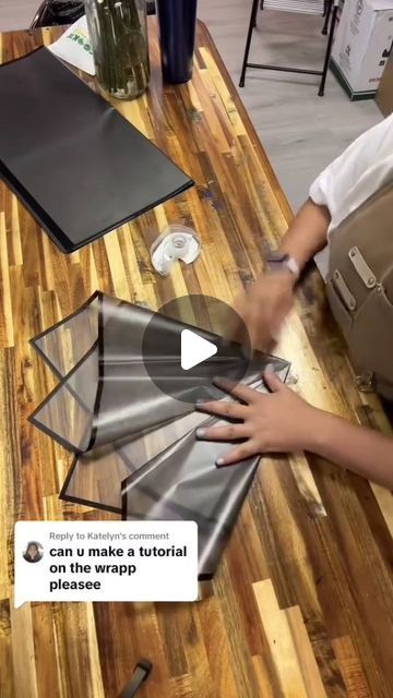 a person cutting glass on top of a wooden table